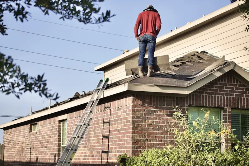 Professional roofer working on a residential roof in Little Turtle